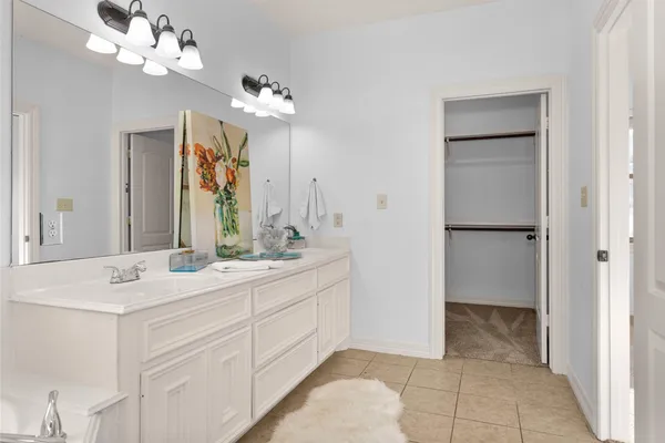 a bathroom with a granite countertop shower a toilet and a sink