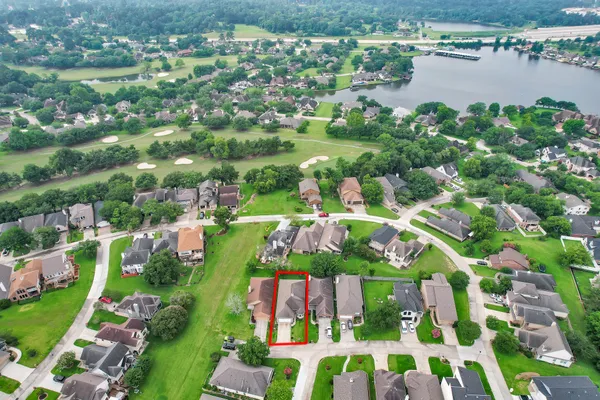 an aerial view of multiple houses with yard
