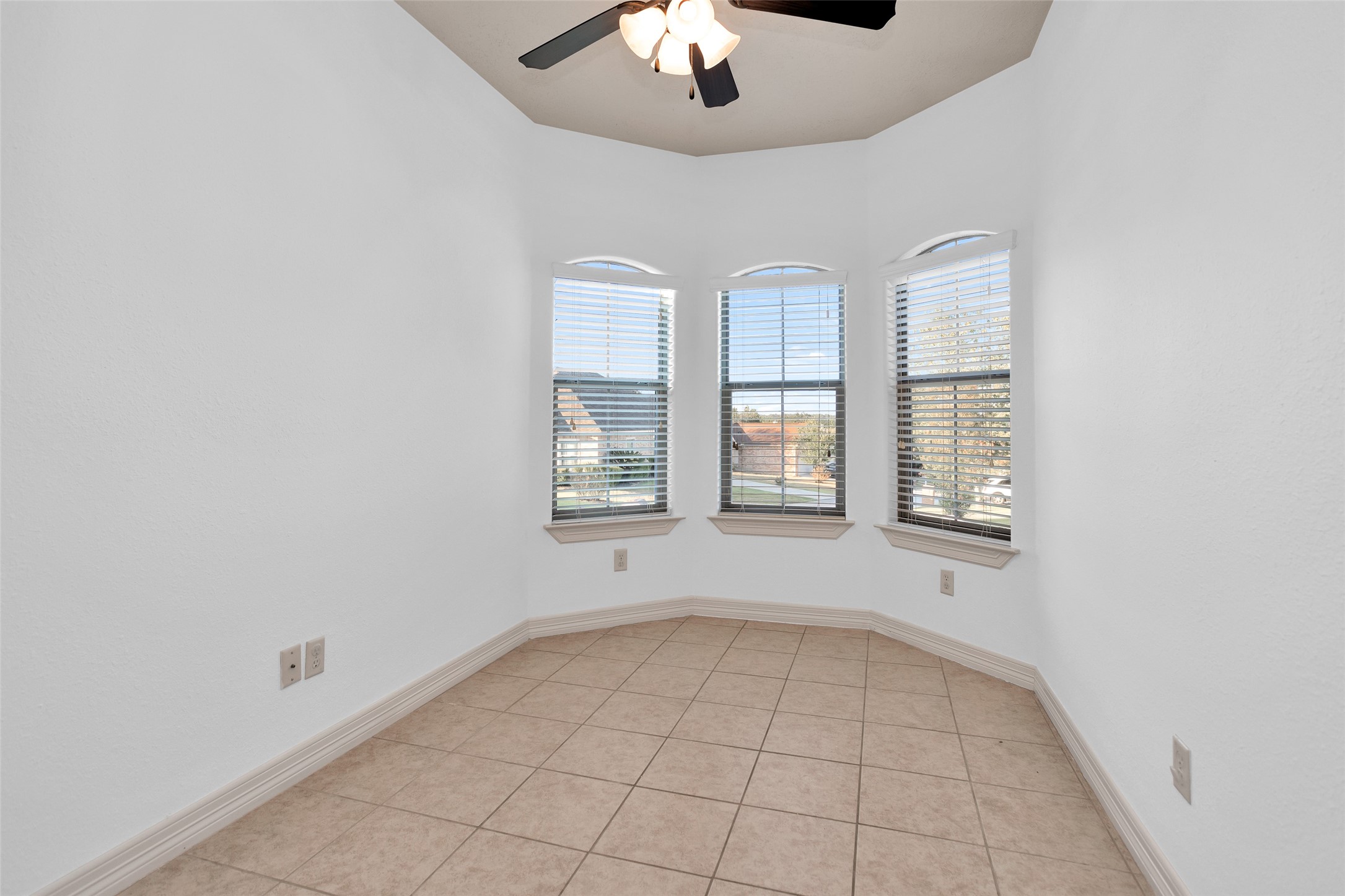 111 Cove Place Montgomery, TX 77356 - Photo 20 of 29 an empty room with windows and chandelier fan