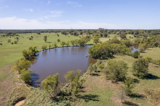 an aerial view of a houses with a yard