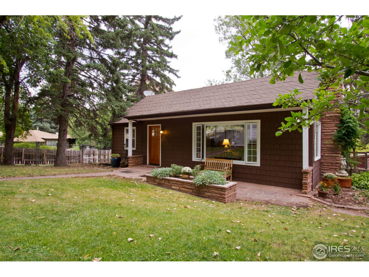 732 Apple Valley Road Lyons, CO 80540 - Photo 1 of 25 a front view of a house with a garden
