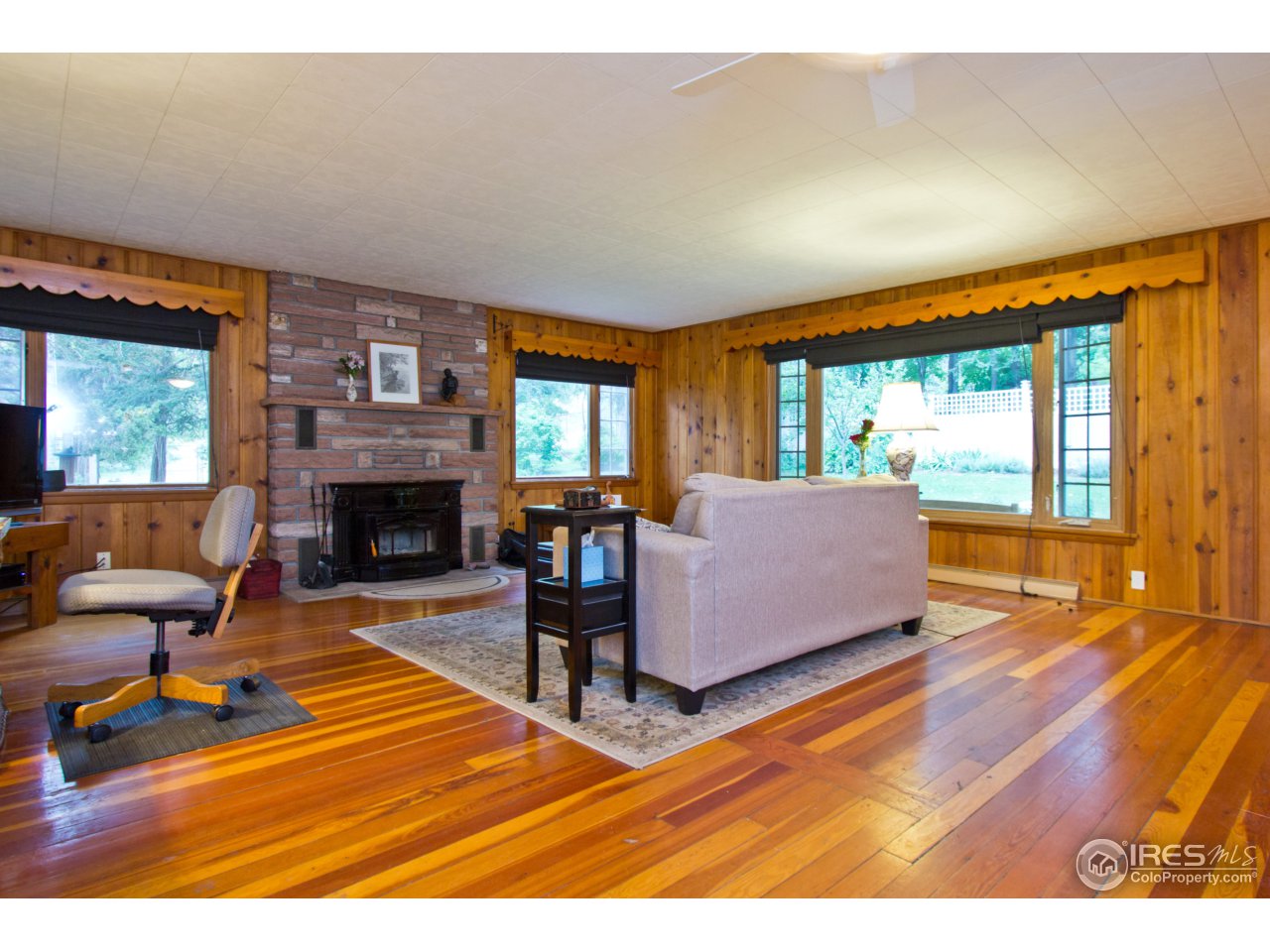 732 Apple Valley Road Lyons, CO 80540 - Photo 6 of 25 a living room with furniture and a fireplace