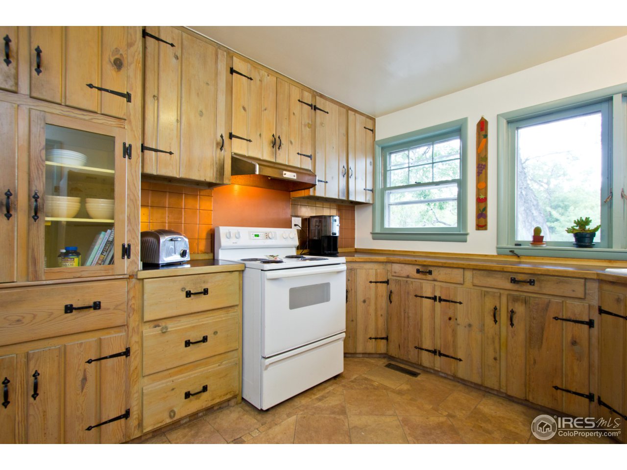 732 Apple Valley Road Lyons, CO 80540 - Photo 7 of 25 a kitchen with granite countertop white cabinets and window