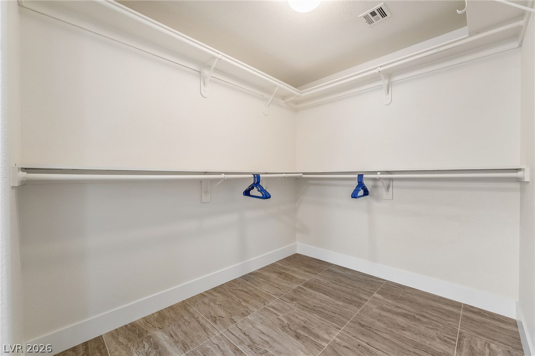 104 Appian Way Henderson, NV 89002 - Photo 18 of 24 An organized walk-in closet with ample shelving and hanging space.