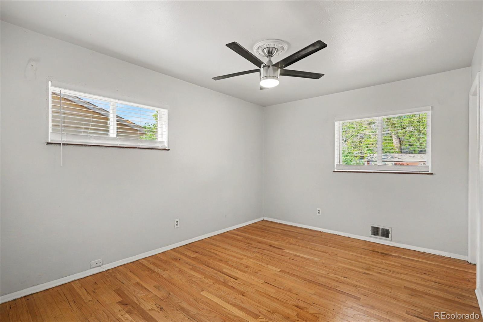 3217 South Stuart Street Denver, CO 80236 - Photo 16 of 29 a view of a big room with wooden floor and windows