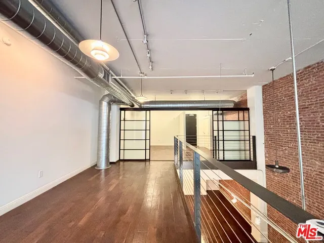 a view of hallway with wooden floor