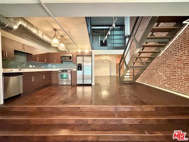 a view of a kitchen with a sink and cabinets