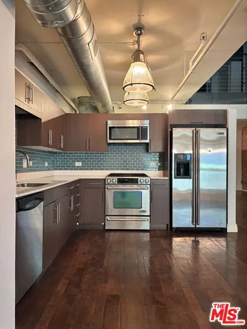 a kitchen with stainless steel appliances granite countertop a stove and a refrigerator