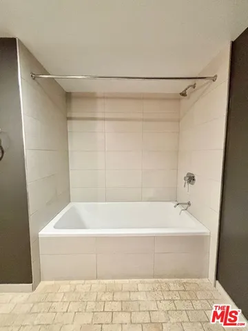 a bathroom with a bathtub and shower