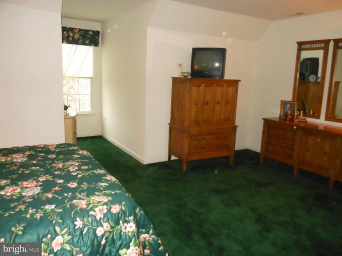 3603 Jackson Cabin Road Phoenix, MD 21131 - Photo 1 of 30 a bedroom with a bed and wooden floor