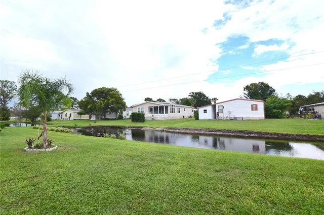 a view of building with river in front of it