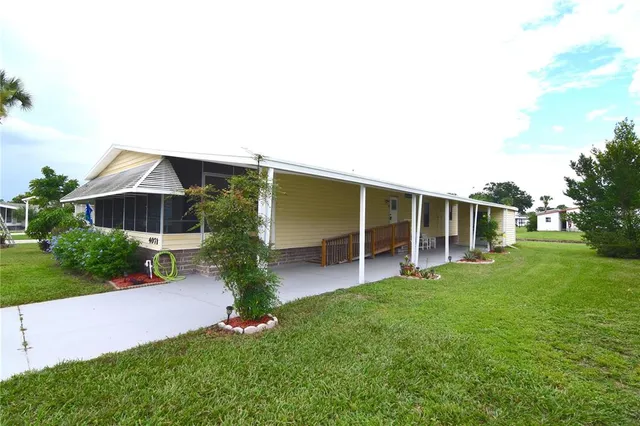 a front view of a house with a yard and trees