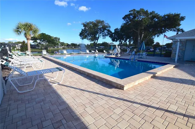 a view of a swimming pool with seating area