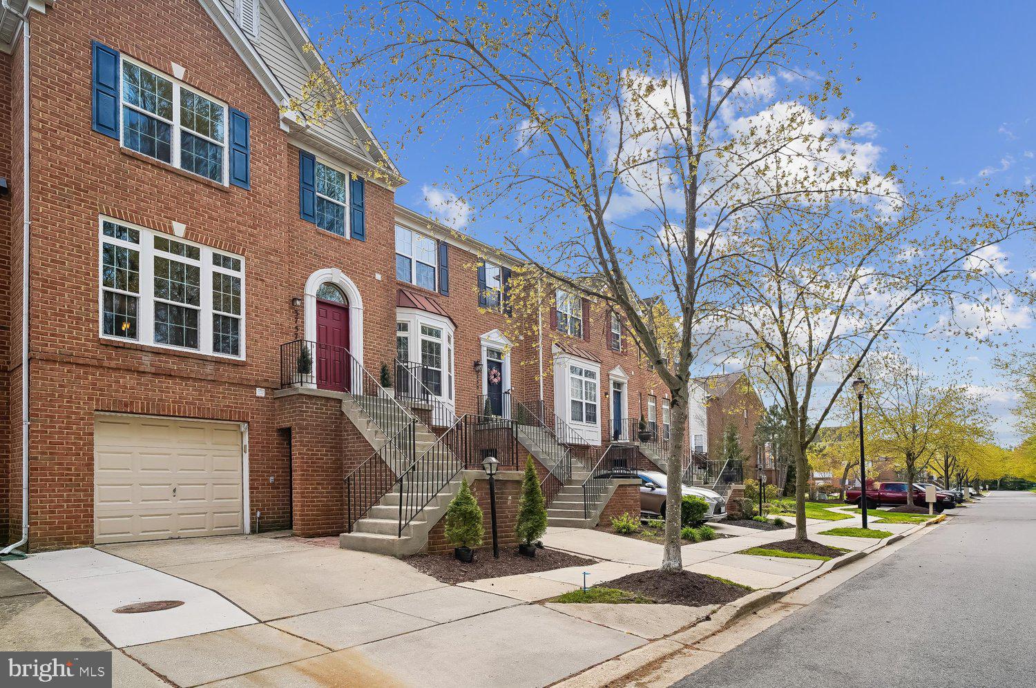 3757 Glebe Meadow Way Edgewater, MD 21037 - Photo 47 of 61 Charming brick townhomes under a blue sky.