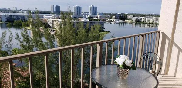 a city view from a balcony with outdoor seating