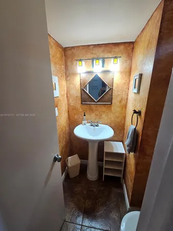 a bathroom with a sink toilet a mirror and vanity