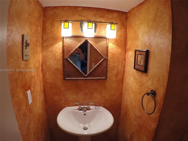 a bathroom with a sink mirror and vanity