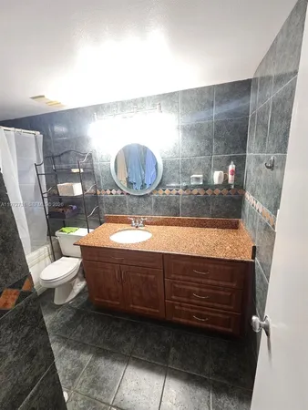 a bathroom with a bathtub and a toilet