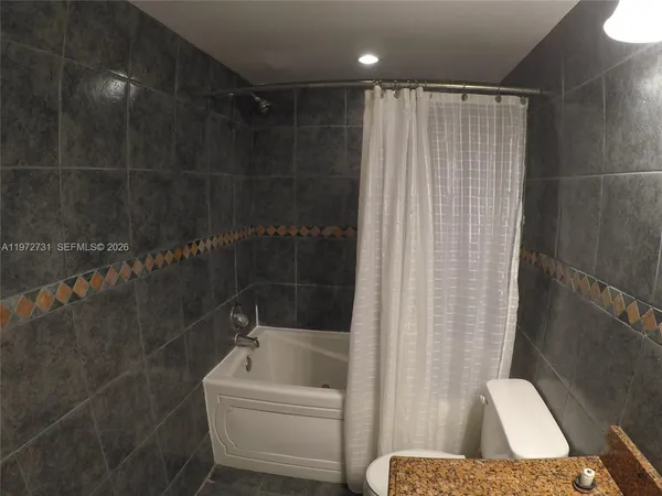 a bathroom with a bathtub and shower