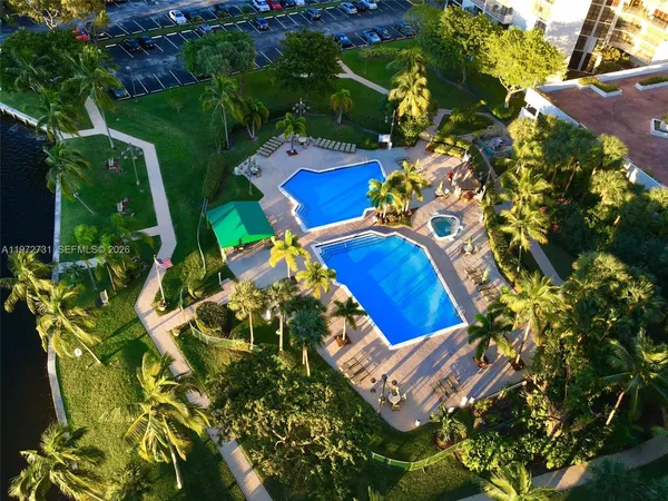 an aerial view of a house with a yard and garden