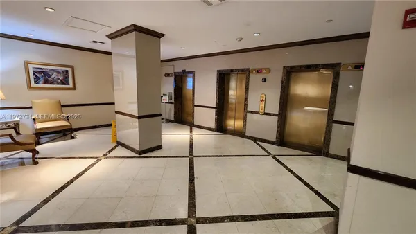 a view of a refrigerator in kitchen and windows