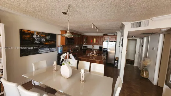 a dining room with furniture and a flat screen tv