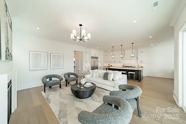 a living room with furniture a dining table and kitchen view