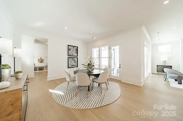 a dining room with furniture a rug and a chandelier