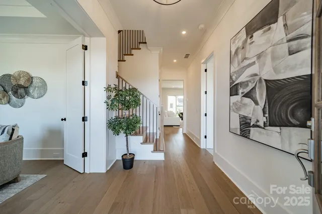 a view of a hallway view with wooden floor and staircase