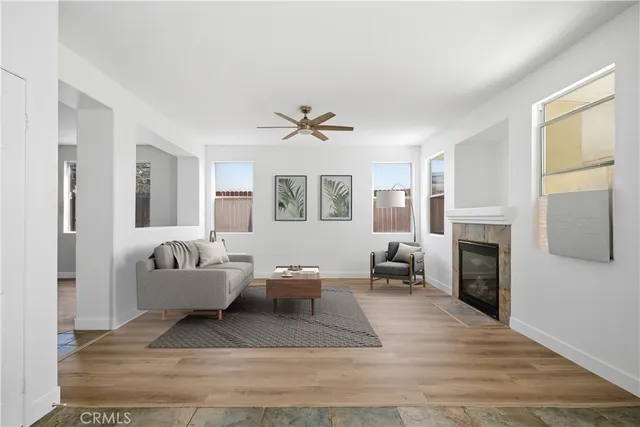 a living room with furniture a fireplace and a window