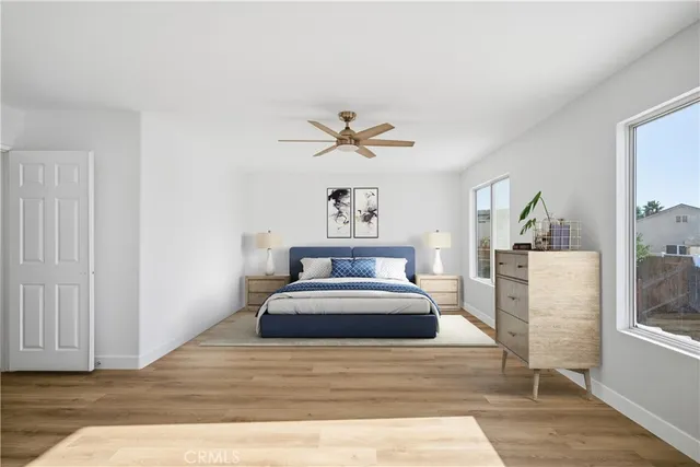 a bedroom with a large bed and a chandelier