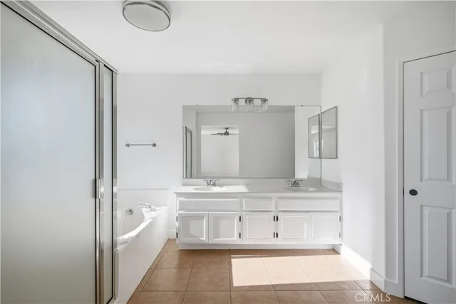 a bathroom with a tub sink and mirror