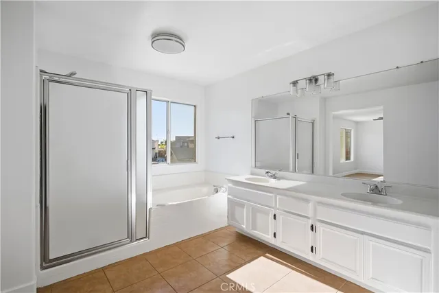 a spacious bathroom with a granite countertop sink mirror and bathtub