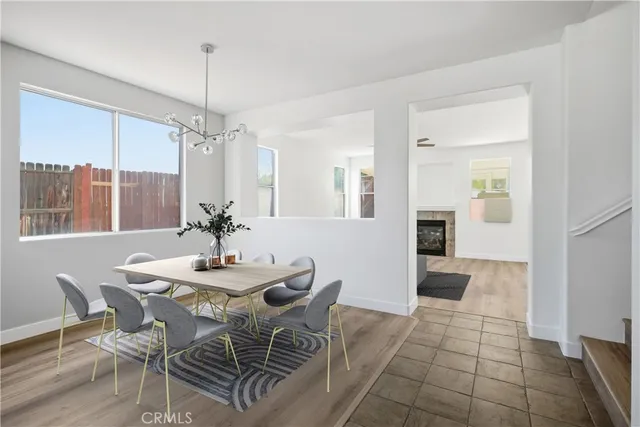 a dining room with furniture a chandelier and window