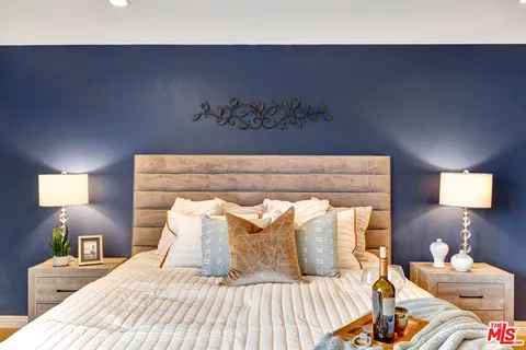 a bedroom with a bed and a lamp
