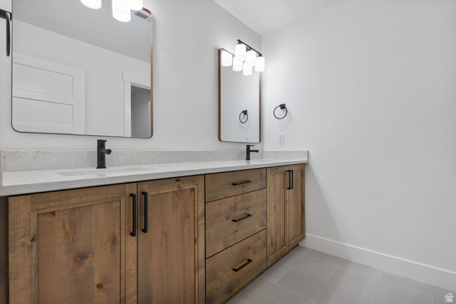 692 East Mountain Road North Ogden, UT 84414 - Photo 21 of 35 Double vanity featuring wood-finish cabinetry, integrated sinks, white countertops, and matte black fixtures