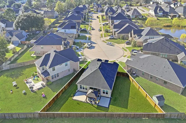 an aerial view of a tennis ground and a large pool