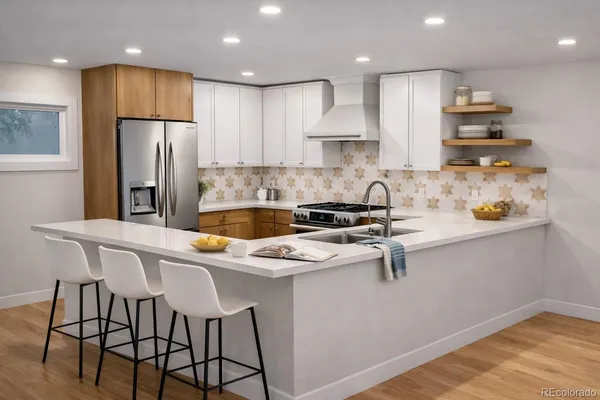 a kitchen with stainless steel appliances granite countertop a sink a stove a refrigerator and island with wooden floor