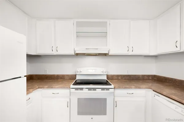 a stove top oven sitting inside of a kitchen