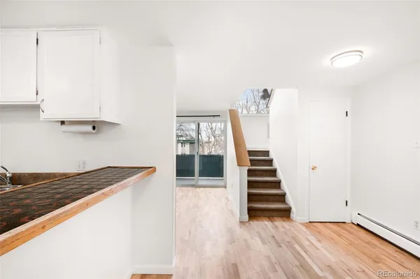 a view of a kitchen with stairs and ventilation