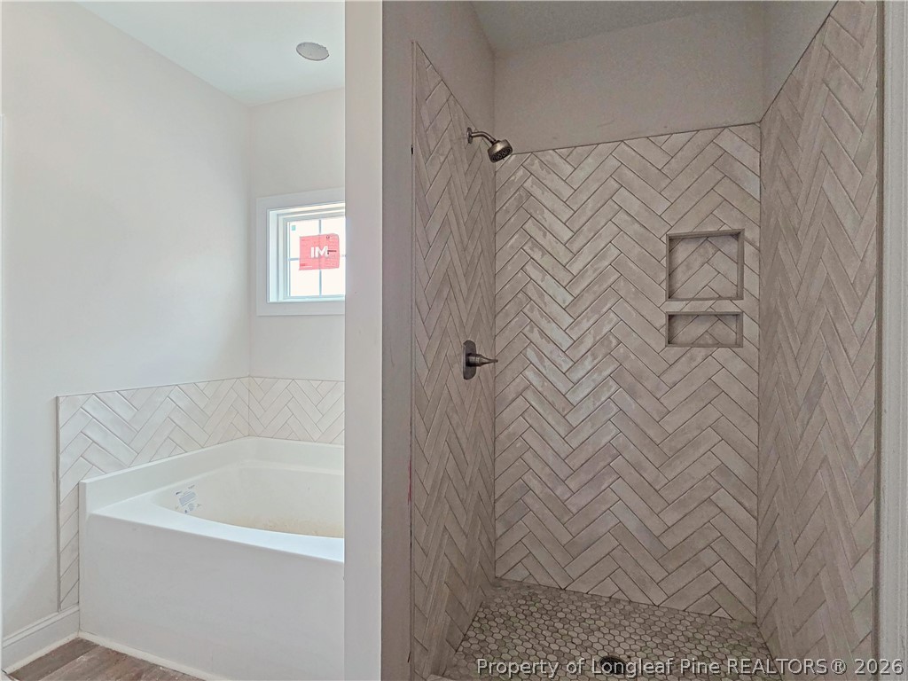 2678 Norrington Road Lillington, NC 27546 - Photo 14 of 31 a bathroom with a bathtub and a shower