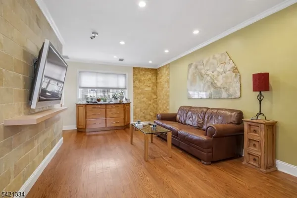 a kitchen with stainless steel appliances granite countertop a stove top oven a refrigerator a sink and a dining table with granite countertops