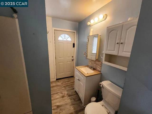 a bathroom with a toilet sink and mirror