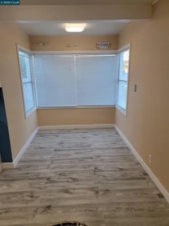 a view of room with wooden floor