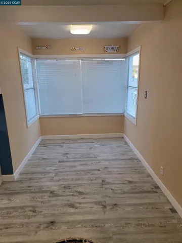 a view of room with wooden floor