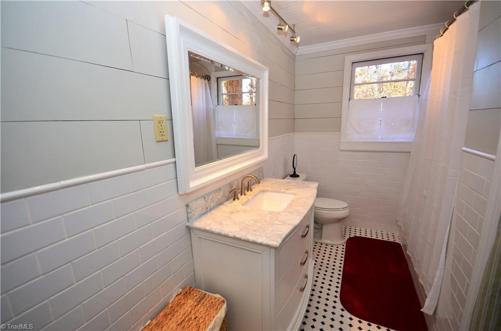 3019 W.O.W. Road Randleman, NC 27317 - Photo 12 of 23 Completely remodeled bathroom with new walls, tile floor, vanity, toilet and re-glazed antique tub
