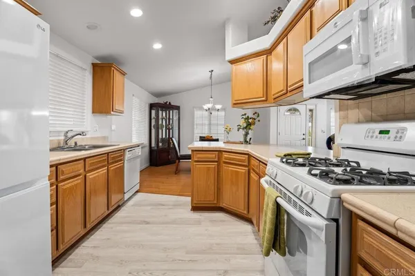 a kitchen with stainless steel appliances granite countertop a stove a sink and a refrigerator