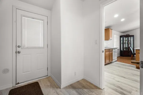 an empty room with wooden floor and closet