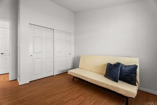 a living room with a couch and a wooden floor