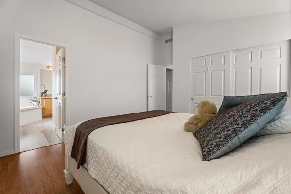 a bedroom with a bed and wooden floor